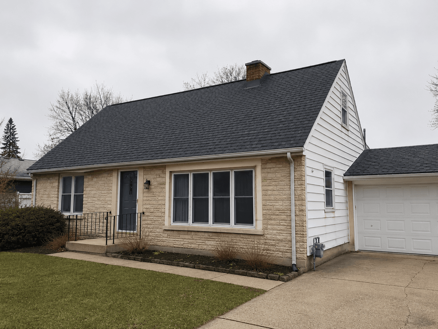New charcoal architectural shingle roof after replacement.